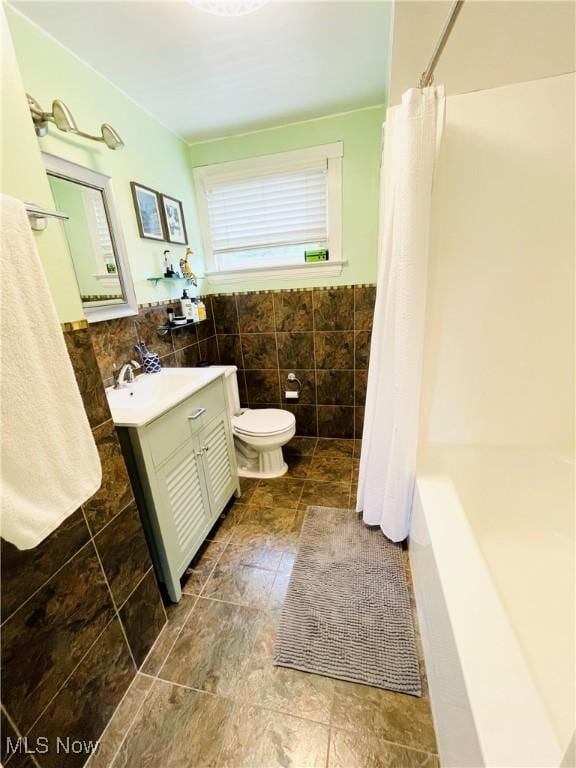 1630 Olivewood Ave, Lakewood, OH 44107 - bathroom with vanity, toilet, and tile walls