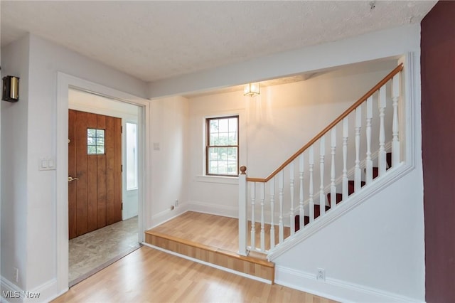 2224 Emily Ave, Lakewood, OH 44107 - entryway featuring wood finished floors, stairway, plenty of natural light, and baseboards