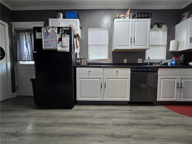 815 Denman Ave, Coshocton, OH 43812 - kitchen featuring black appliances, crown molding, dark countertops, light wood-style floors, and white cabinets