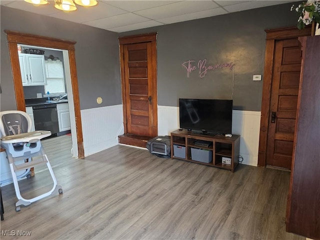 815 Denman Ave, Coshocton, OH 43812 - living area with wainscoting, wood finished floors, and a drop ceiling