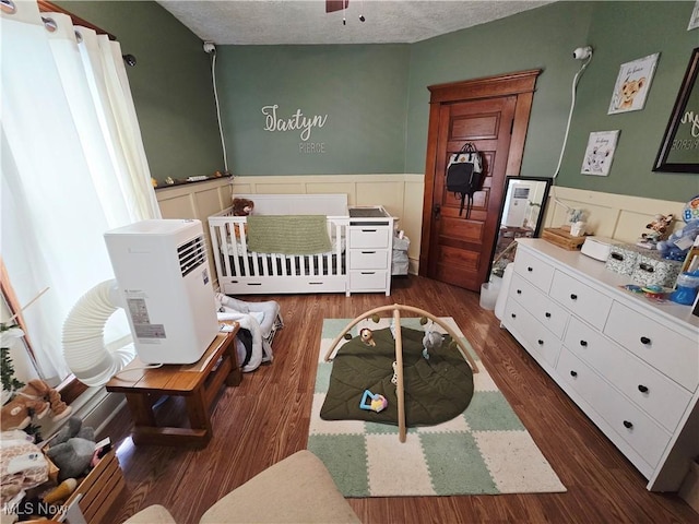 815 Denman Ave, Coshocton, OH 43812 - bedroom featuring wainscoting, wood finished floors, and a textured ceiling