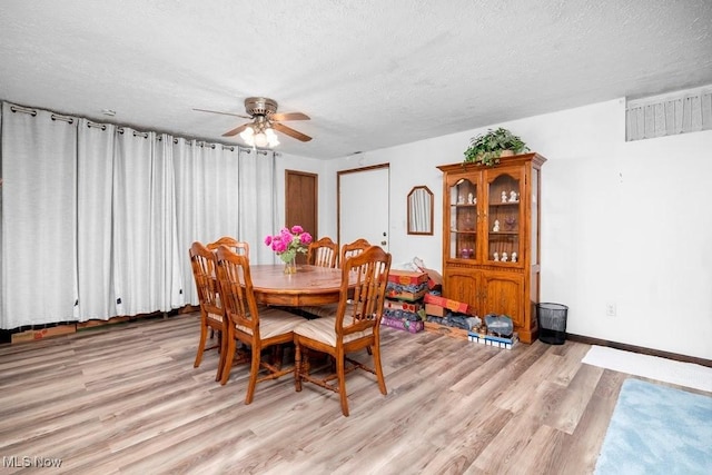 10877 Butternut Ridge Rd, Elyria, OH 44035 - dining area featuring a ceiling fan, light wood-type flooring, a textured ceiling, and baseboards