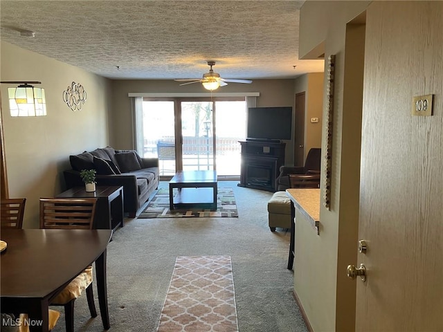 19510 Lorain Rd, Fairview Park, OH 44126 - living room with carpet flooring, a textured ceiling, ceiling fan, and a fireplace