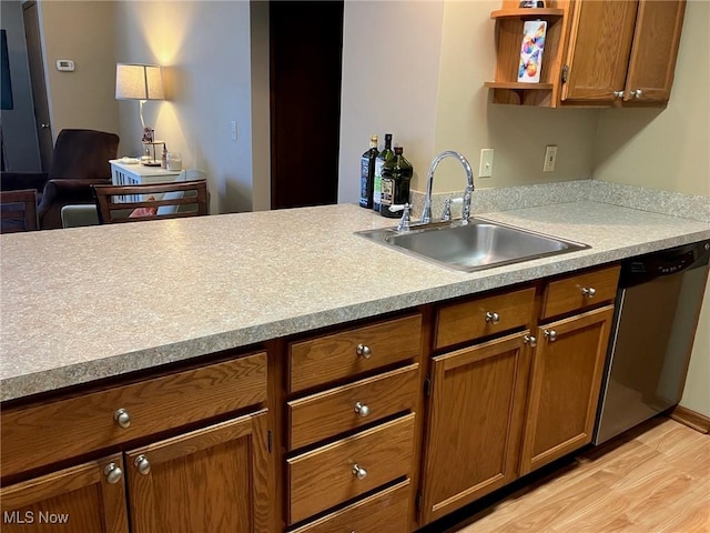 19510 Lorain Rd, Fairview Park, OH 44126 - kitchen with dishwasher, a sink, light wood-type flooring, brown cabinetry, and light countertops