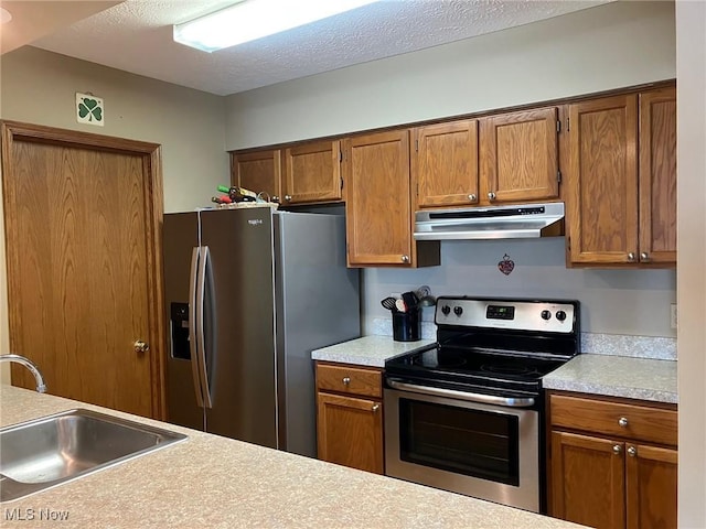 19510 Lorain Rd, Fairview Park, OH 44126 - kitchen featuring under cabinet range hood, stainless steel appliances, a sink, light countertops, and brown cabinets