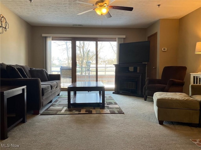 19510 Lorain Rd, Fairview Park, OH 44126 - carpeted living area featuring a fireplace, a textured ceiling, and a ceiling fan