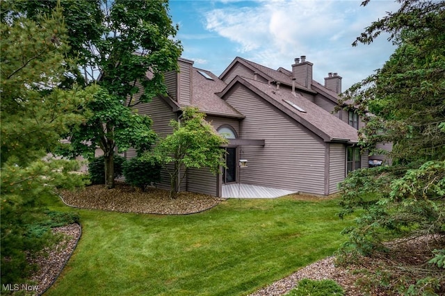 6465 Saint Andrews Dr Unit 6, Canfield, OH 44406 - view of home's exterior with a chimney, a lawn, and a shingled roof