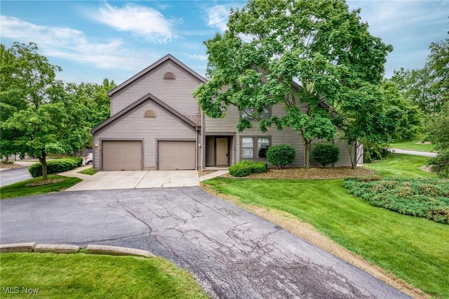6465 Saint Andrews Dr Unit 6, Canfield, OH 44406 - view of front of house featuring asphalt driveway, a front yard, and a garage