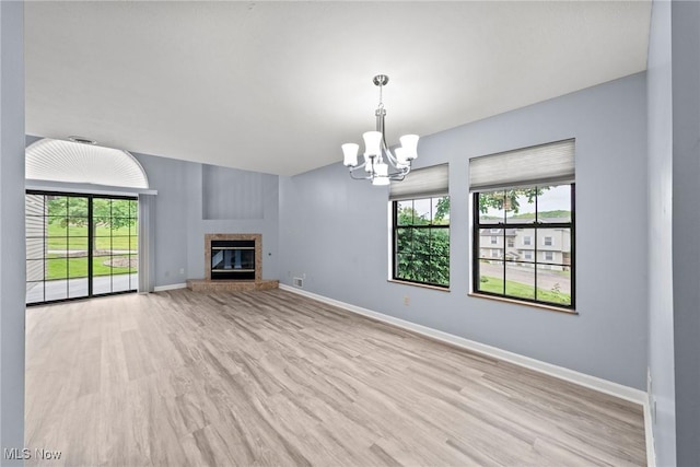 6465 Saint Andrews Dr Unit 6, Canfield, OH 44406 - unfurnished living room featuring a chandelier, light wood-type flooring, and baseboards