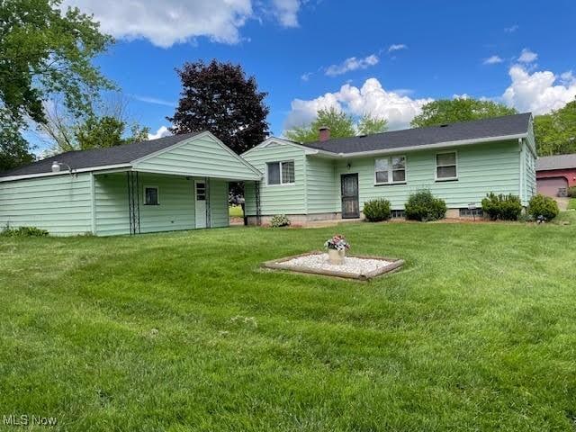 1148 Miami Ave, Youngstown, OH 44505 - back of house featuring a lawn