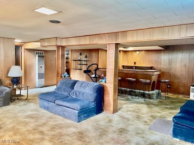 1148 Miami Ave, Youngstown, OH 44505 - carpeted living room with wooden walls and a dry bar