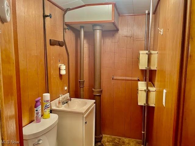 1148 Miami Ave, Youngstown, OH 44505 - bathroom with toilet, wood walls, and vanity