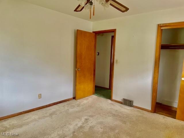 1148 Miami Ave, Youngstown, OH 44505 - unfurnished bedroom featuring carpet, baseboards, a closet, and a ceiling fan