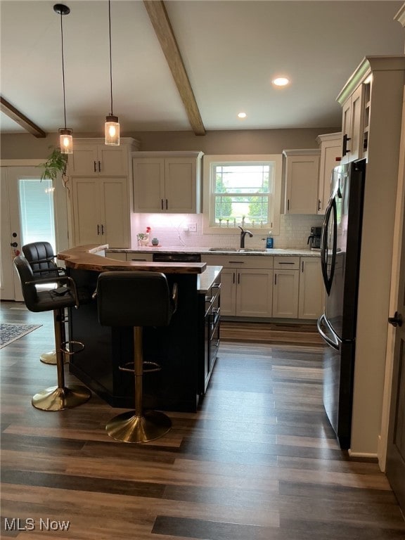 7030 Jones Rd, Nashport, OH 43830 - kitchen featuring freestanding refrigerator, a sink, tasteful backsplash, beam ceiling, and light countertops
