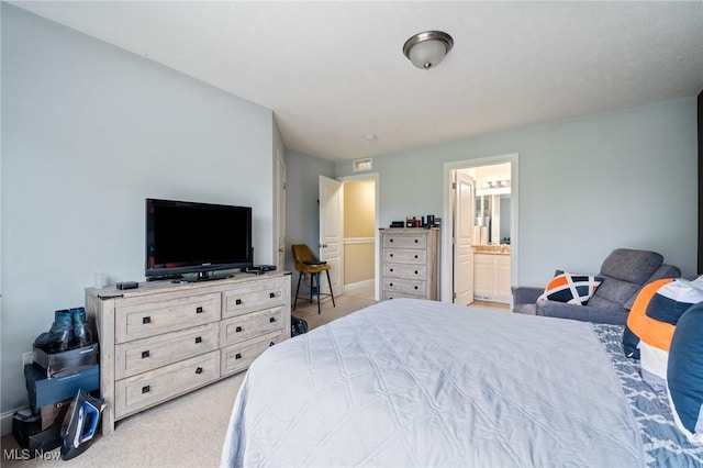 3128 E 135th St Unit 4, Cleveland, OH 44120 - carpeted bedroom with baseboards and ensuite bathroom