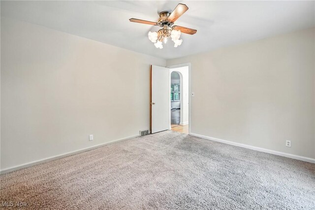 2506 Bears Den Rd, Youngstown, OH 44511 - carpeted spare room with a ceiling fan, arched walkways, and baseboards