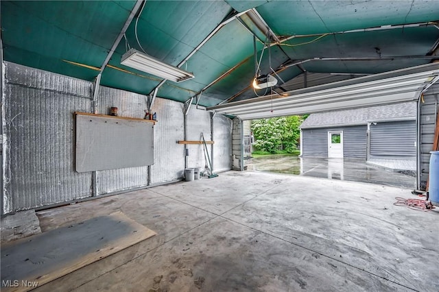 2506 Bears Den Rd, Youngstown, OH 44511 - garage with a garage door opener and a ceiling fan