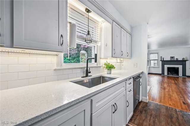 2506 Bears Den Rd, Youngstown, OH 44511 - kitchen with a sink, decorative backsplash, dark wood-type flooring, light stone counters, and pendant lighting