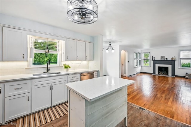 2506 Bears Den Rd, Youngstown, OH 44511 - kitchen with a sink, a chandelier, dishwasher, arched walkways, and dark wood-style flooring