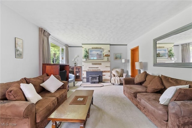 4937 Stevens Rd, Akron, OH 44319 - living room with a wood stove, carpet flooring, and a textured ceiling