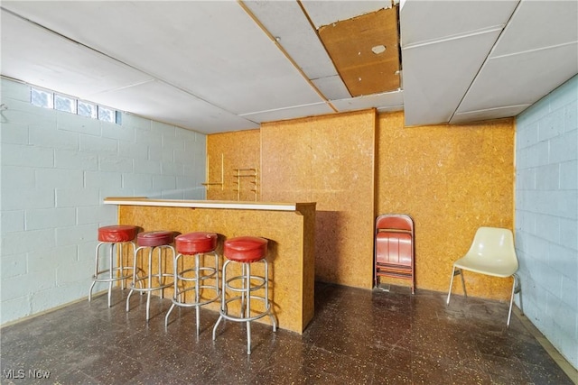 4937 Stevens Rd, Akron, OH 44319 - indoor dry bar with tile patterned floors and concrete block wall