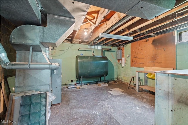 4937 Stevens Rd, Akron, OH 44319 - below grade area featuring oil tank, a workshop area, and electric panel
