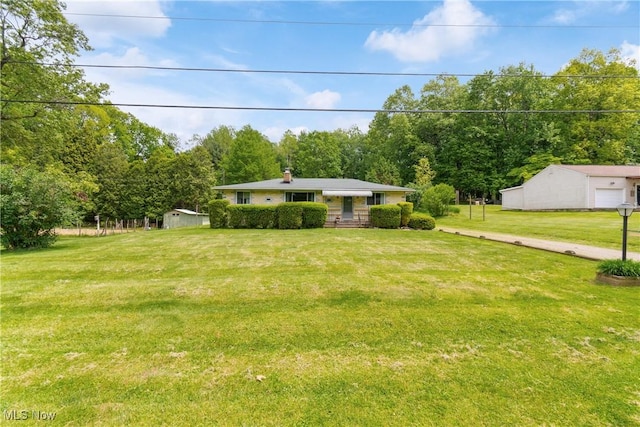 4937 Stevens Rd, Akron, OH 44319 - view of green lawn featuring an outbuilding