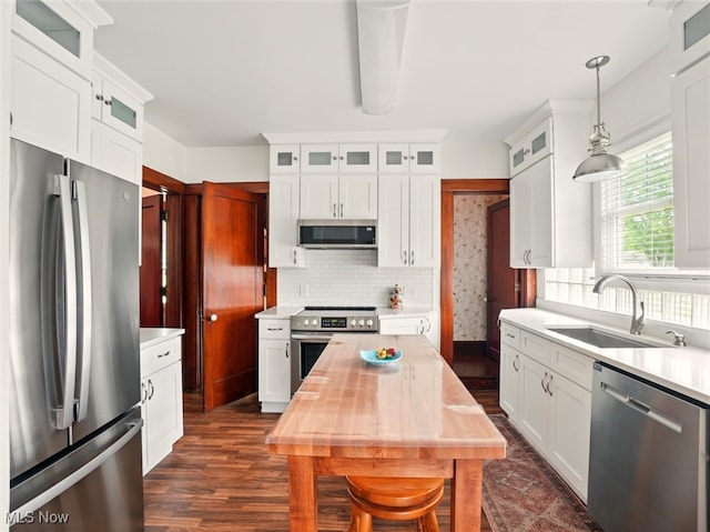 126 W Jefferson St, Jefferson, OH 44047 - kitchen with stainless steel appliances, a sink, light countertops, dark wood-style floors, and white cabinets