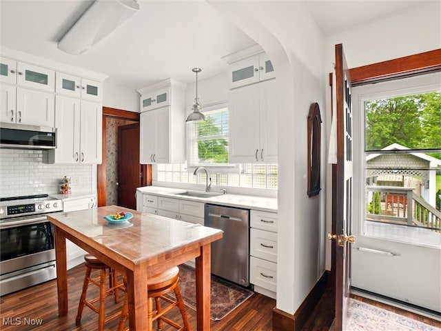 126 W Jefferson St, Jefferson, OH 44047 - kitchen featuring stainless steel appliances, a sink, light countertops, decorative backsplash, and white cabinets