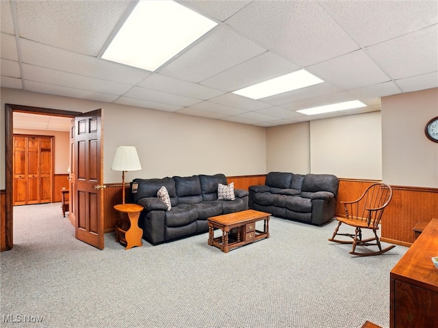 126 W Jefferson St, Jefferson, OH 44047 - living area featuring a wainscoted wall, carpet flooring, wood walls, and a paneled ceiling