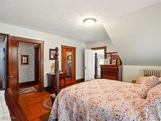 126 W Jefferson St, Jefferson, OH 44047 - bedroom with radiator, wood finished floors, and baseboards