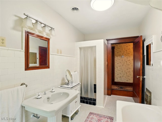 126 W Jefferson St, Jefferson, OH 44047 - bathroom featuring tile walls, wainscoting, and tile patterned flooring
