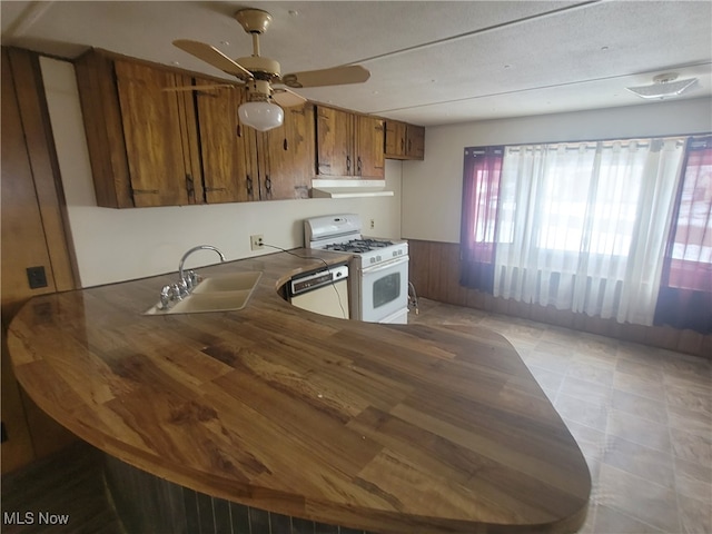 71 Rustic Ln, Apple Creek, OH 44606 - kitchen with white appliances, brown cabinets, under cabinet range hood, a sink, and ceiling fan
