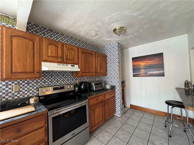 71322 Sharon Rd, Bridgeport, OH 43912 - kitchen featuring stainless steel electric range, under cabinet range hood, brown cabinetry, a textured ceiling, and dark countertops