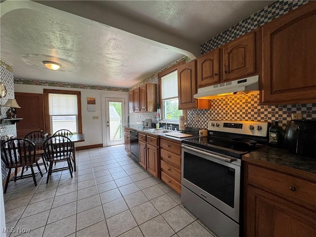 71322 Sharon Rd, Bridgeport, OH 43912 - kitchen featuring stainless steel range with electric cooktop, under cabinet range hood, dishwasher, a textured ceiling, and backsplash