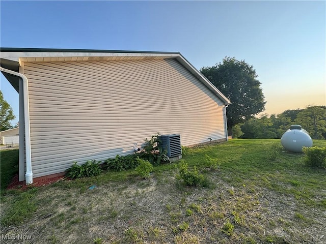 71322 Sharon Rd, Bridgeport, OH 43912 - property exterior at dusk featuring cooling unit and a lawn
