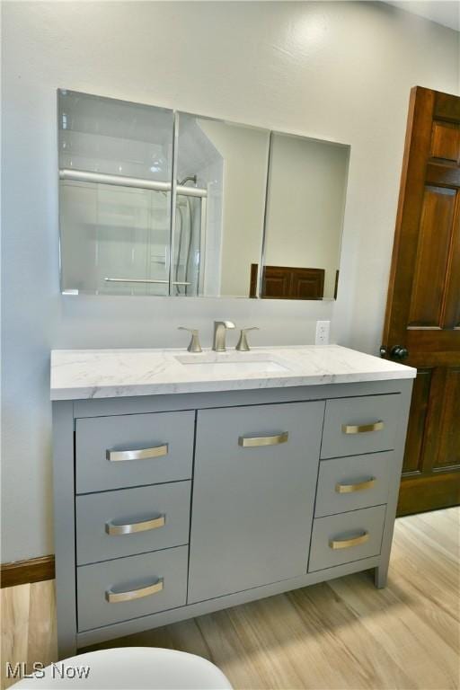 8848 King Graves Rd NE, Warren, OH 44484 - bathroom with vanity, wood finished floors, and a shower stall