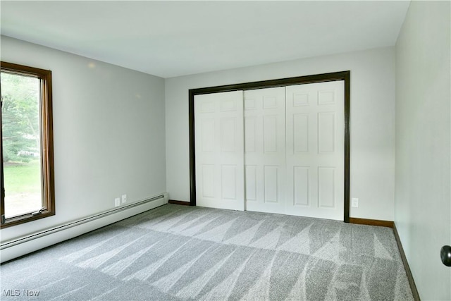 8848 King Graves Rd NE, Warren, OH 44484 - unfurnished bedroom with baseboard heating, multiple windows, and carpet flooring