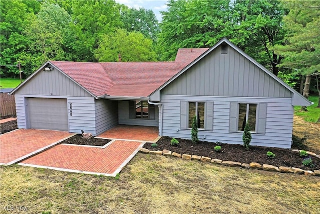 8848 King Graves Rd NE, Warren, OH 44484 - ranch-style house with a garage, a shingled roof, and board and batten siding