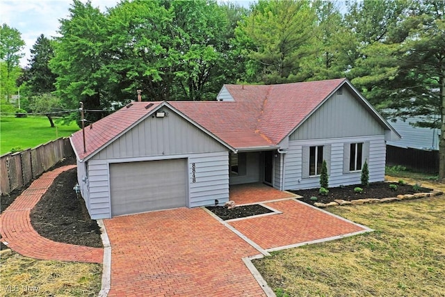 8848 King Graves Rd NE, Warren, OH 44484 - single story home with a garage, decorative driveway, a shingled roof, and board and batten siding
