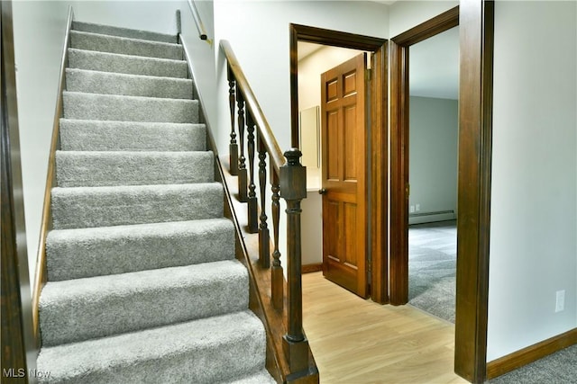 8848 King Graves Rd NE, Warren, OH 44484 - staircase with baseboard heating, wood finished floors, and baseboards