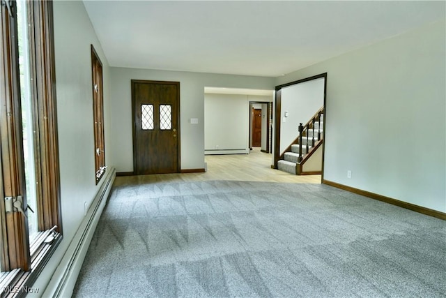 8848 King Graves Rd NE, Warren, OH 44484 - entrance foyer featuring light carpet, baseboard heating, stairway, and baseboards