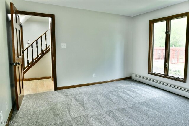 8848 King Graves Rd NE, Warren, OH 44484 - unfurnished room featuring carpet, plenty of natural light, a baseboard heating unit, and baseboards