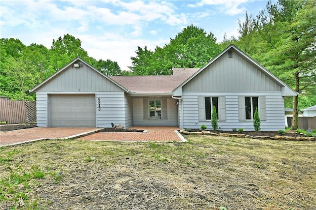 8848 King Graves Rd NE, Warren, OH 44484 - view of front of home featuring a garage, roof with shingles, and driveway