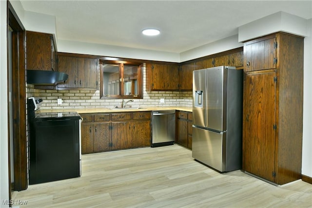 8848 King Graves Rd NE, Warren, OH 44484 - kitchen with stainless steel appliances, a sink, under cabinet range hood, light wood finished floors, and light countertops