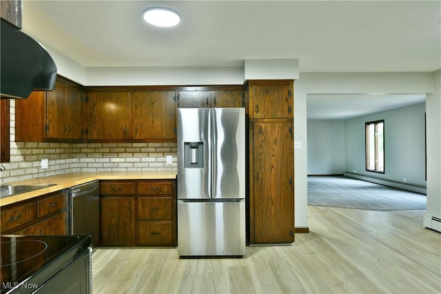 8848 King Graves Rd NE, Warren, OH 44484 - kitchen featuring appliances with stainless steel finishes, a baseboard radiator, a sink, light countertops, and tasteful backsplash