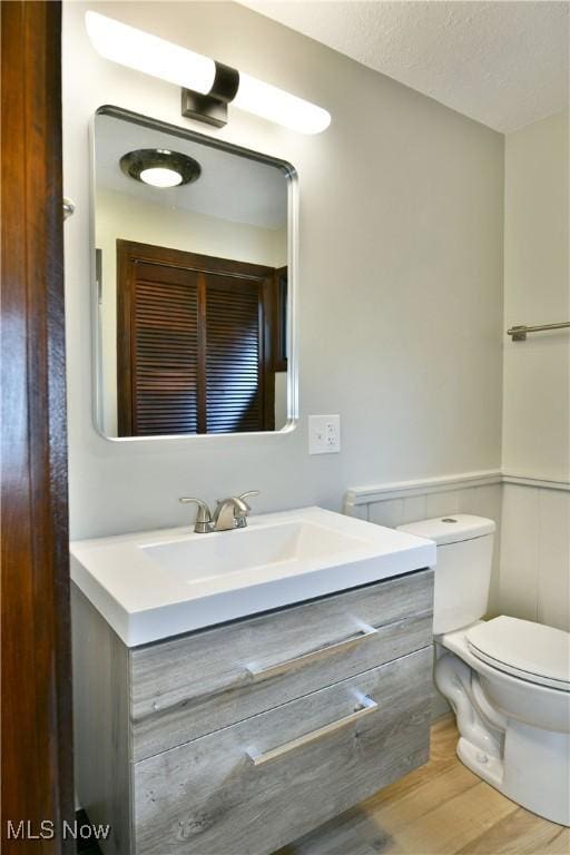 8848 King Graves Rd NE, Warren, OH 44484 - bathroom featuring vanity, toilet, and wood finished floors