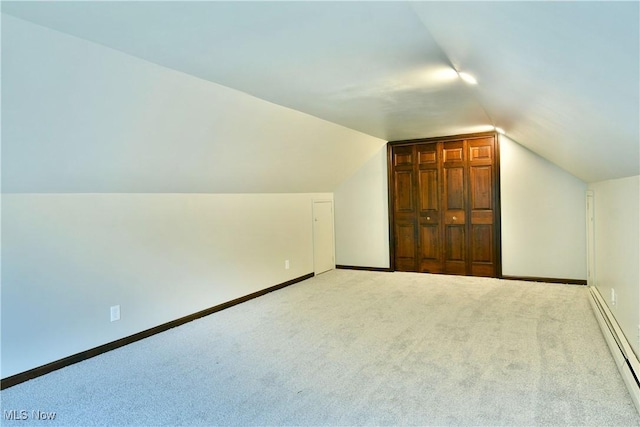 8848 King Graves Rd NE, Warren, OH 44484 - bonus room with a baseboard heating unit, lofted ceiling, carpet floors, and baseboards