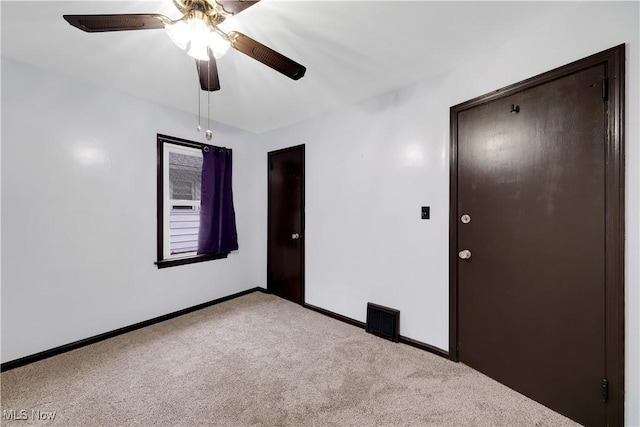 38 Marion Ave, Mogadore, OH 44260 - carpeted spare room with baseboards and a ceiling fan