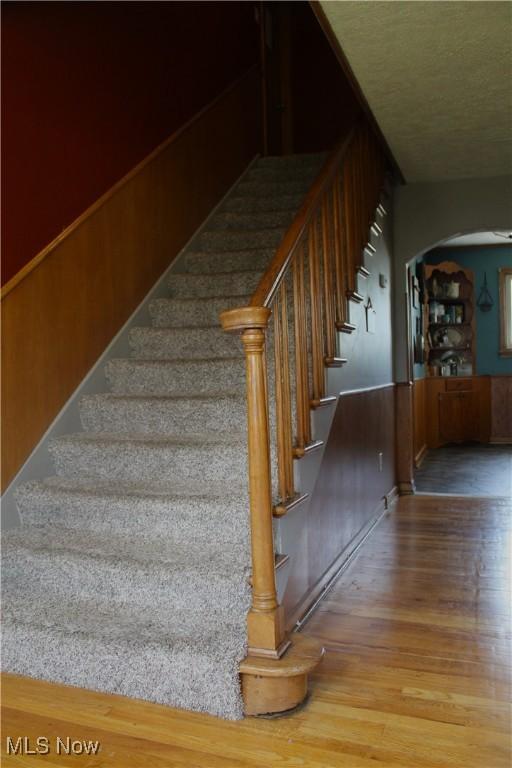 230 Rivercrest Dr, Coshocton, OH 43812 - stairway with arched walkways and wood finished floors